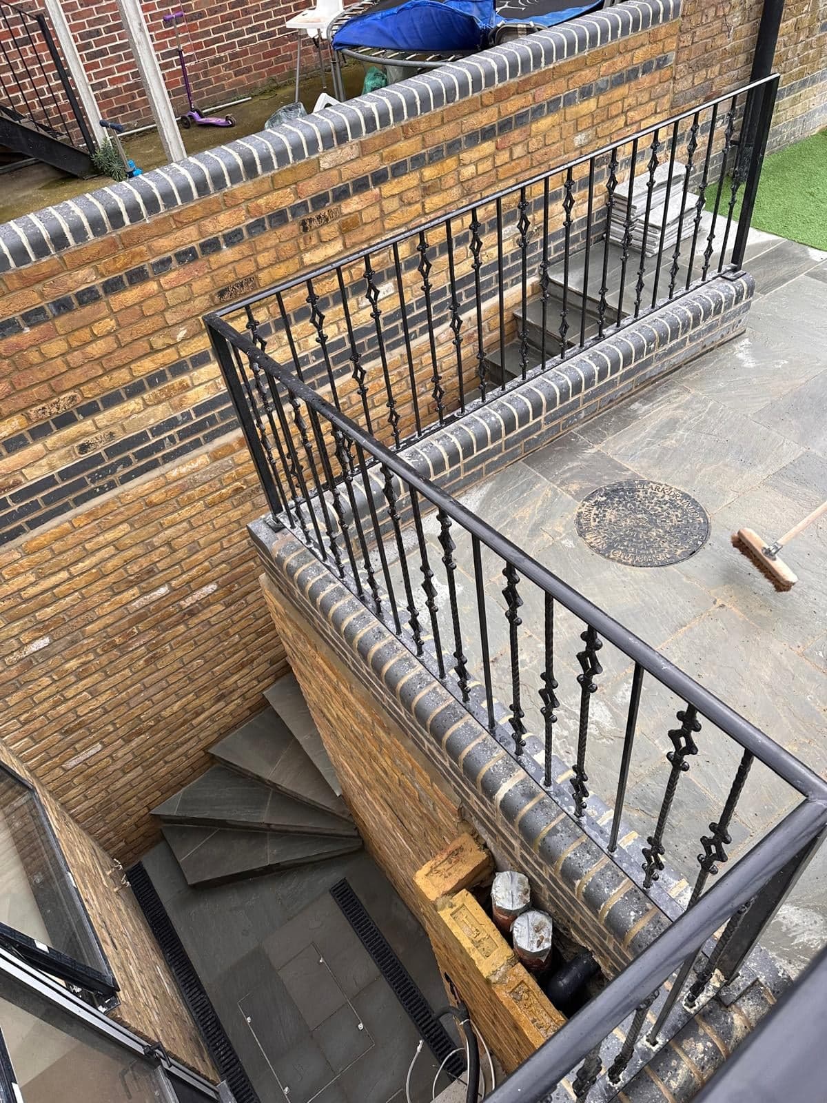 Finished light well with a stone stair and railings down to the basement