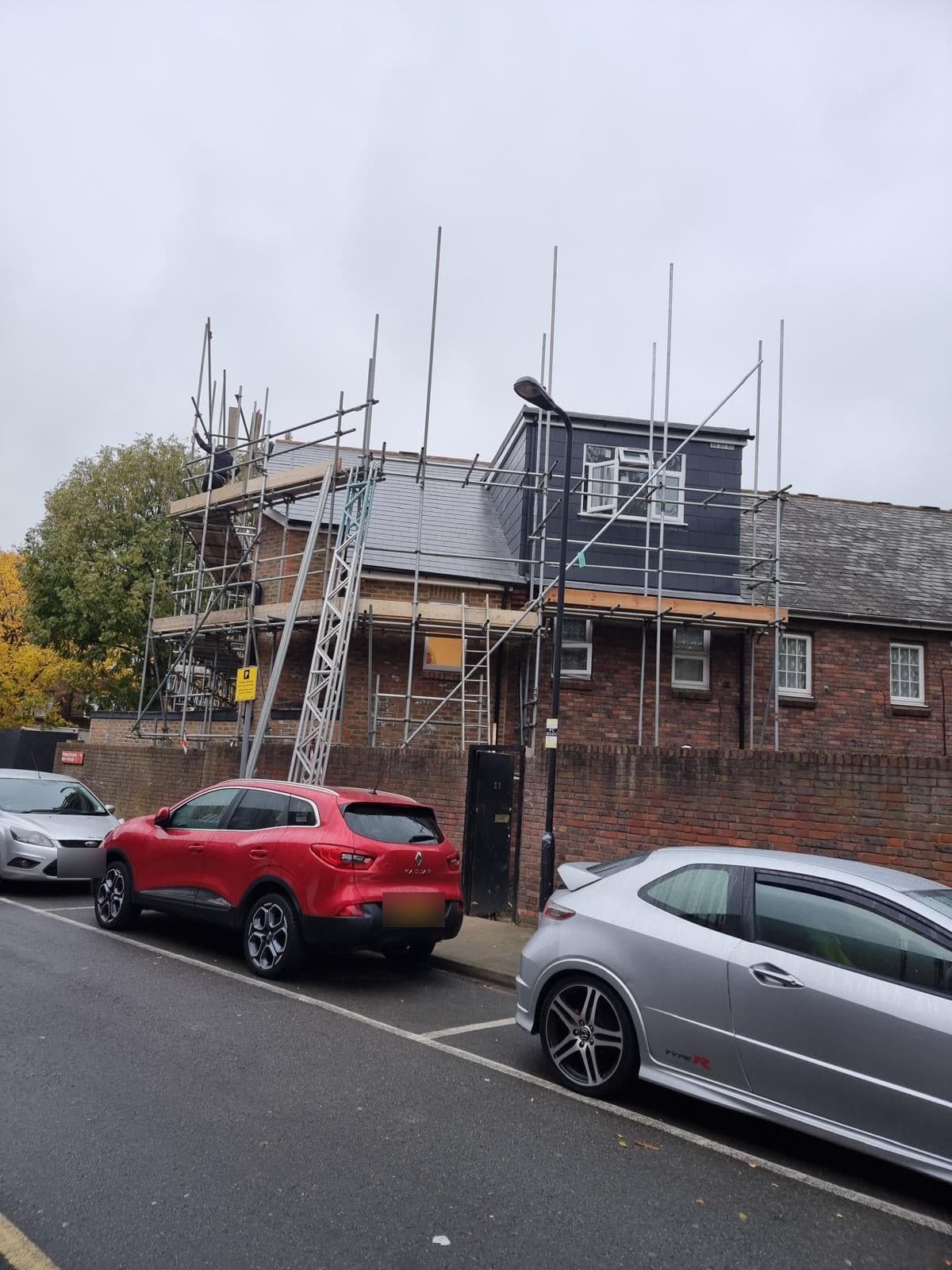 The new house with its roof and dormer on, still under scaffold