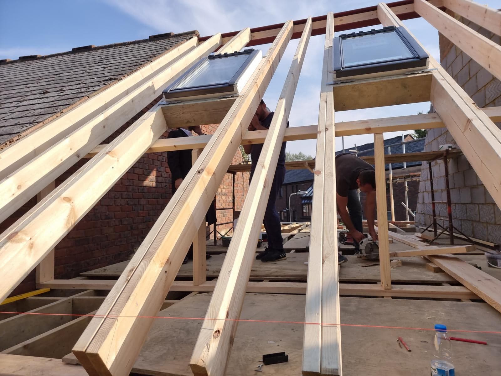 Carpenters fitting the rafters and roof windows