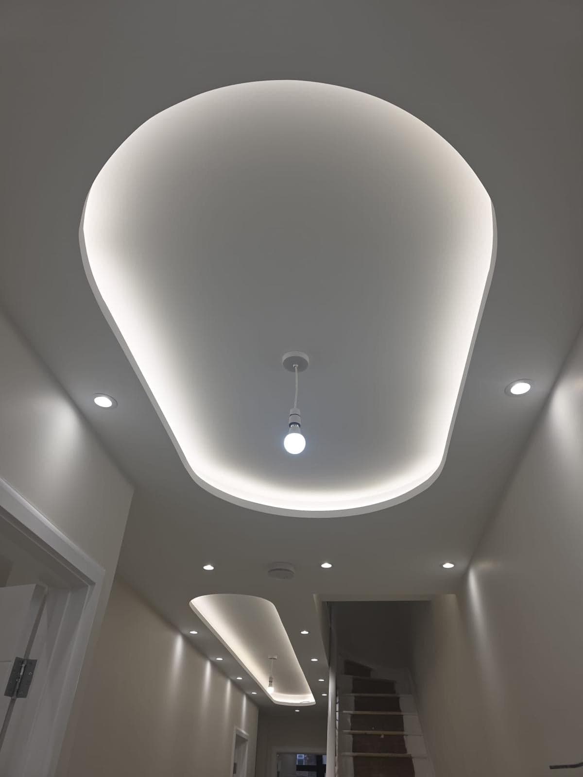Plastered ceiling with a recessed LED cove and downlights along the landing